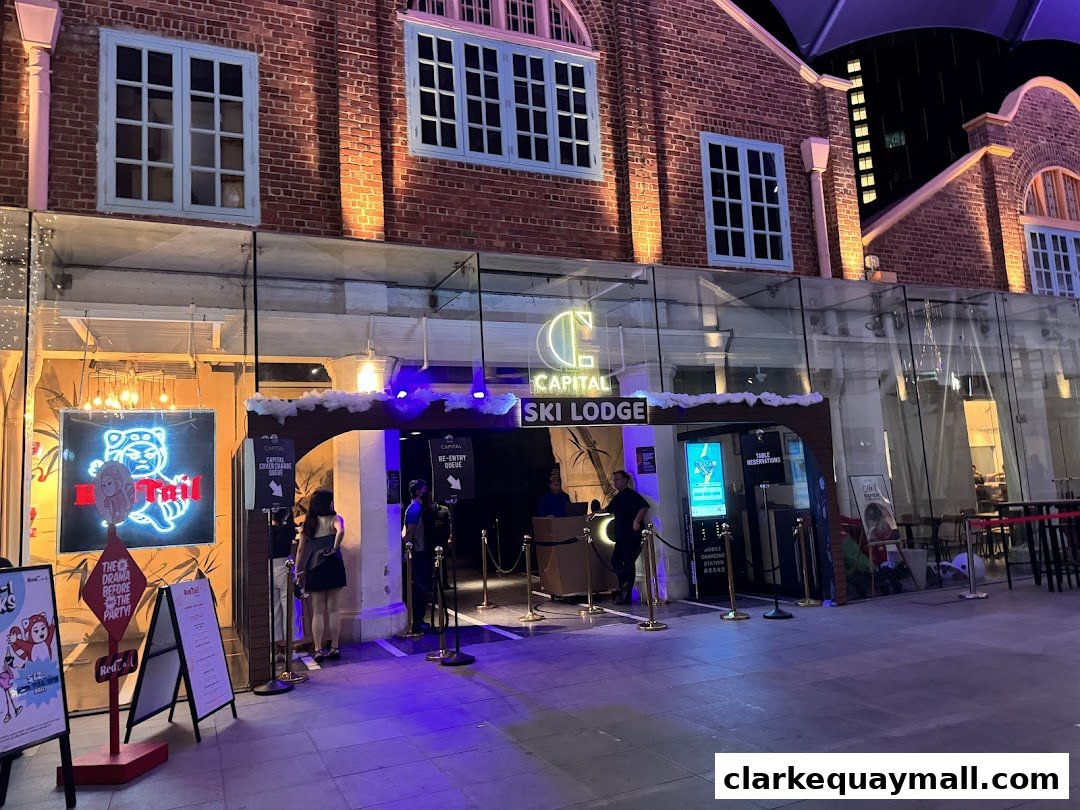 The entrance to Capital Ski Lodge with a neon sign and people queuing.