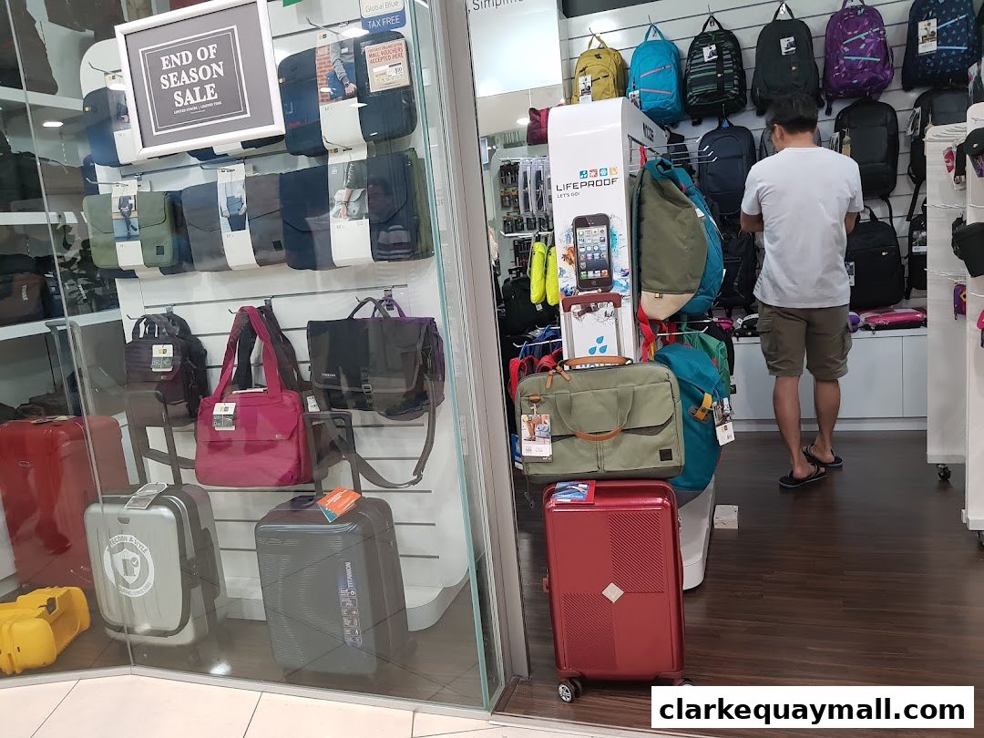 A shop interior displaying a variety of bags, backpacks, and luggage, with an 'End of Season Sale' sign.