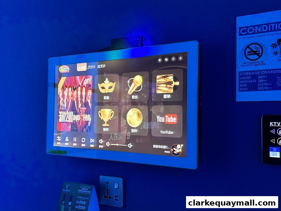 A screen displaying karaoke song options and a corkage charge notice.