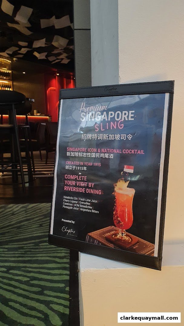 A menu board showcasing the Premium Singapore Sling cocktail with its ingredients.