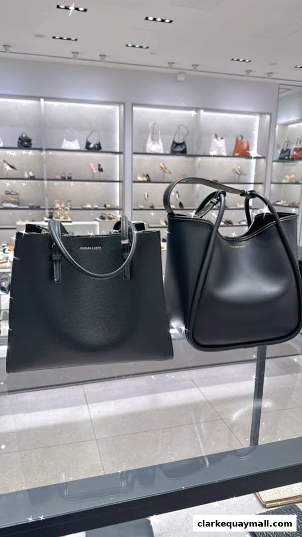 Two stylish black handbags displayed in a well-lit retail store with shelves of shoes in the background.