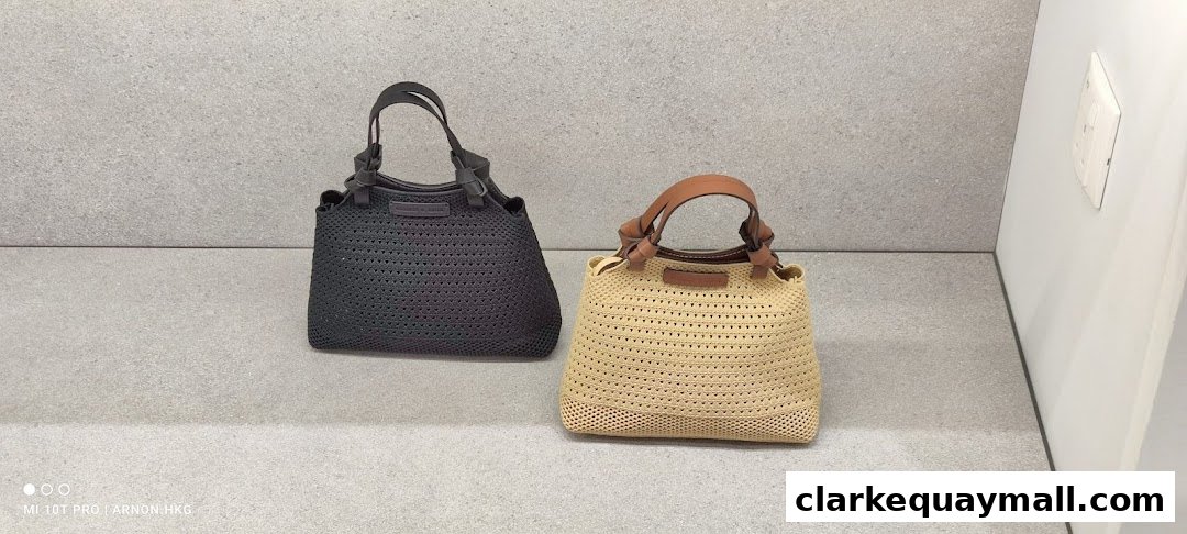 Two stylish woven handbags, one black and one beige, displayed on a grey surface.