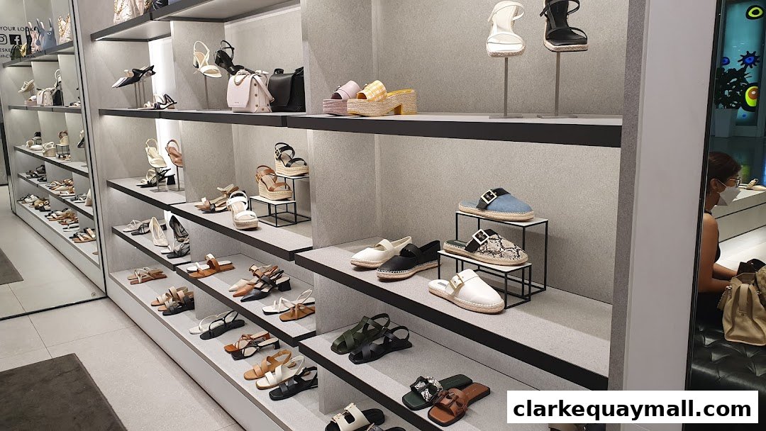 Interior view of a Charles & Keith store showcasing a wide variety of stylish women's shoes and handbags on display shelves.