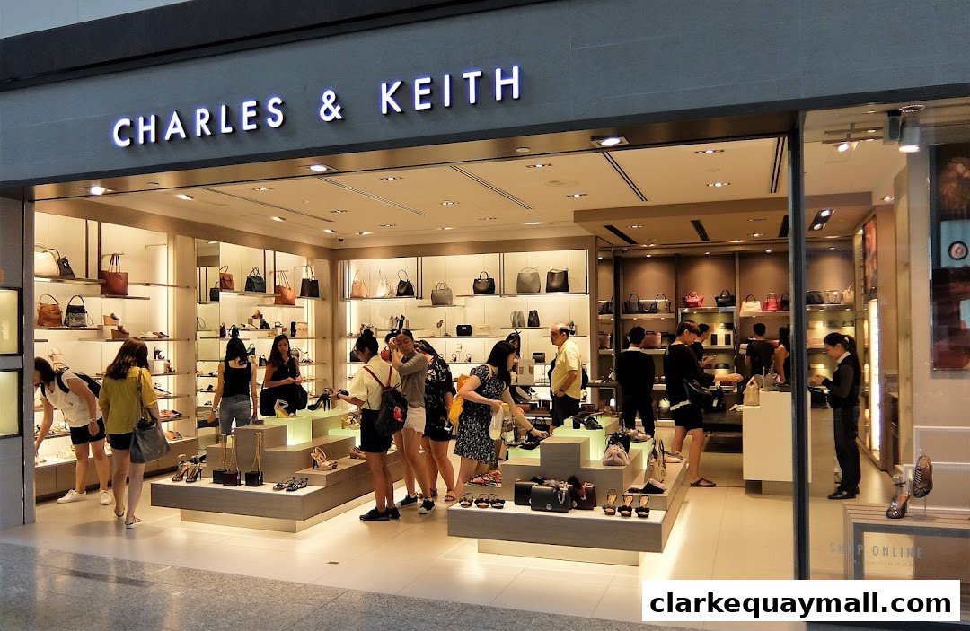 A CHARLES & KEITH store interior showcasing handbags and shoes with customers browsing.