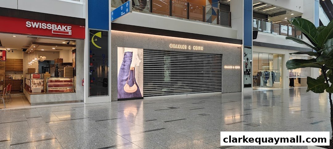 The Charles & Keith store is closed with its roller shutters down, displaying a fashion advertisement.