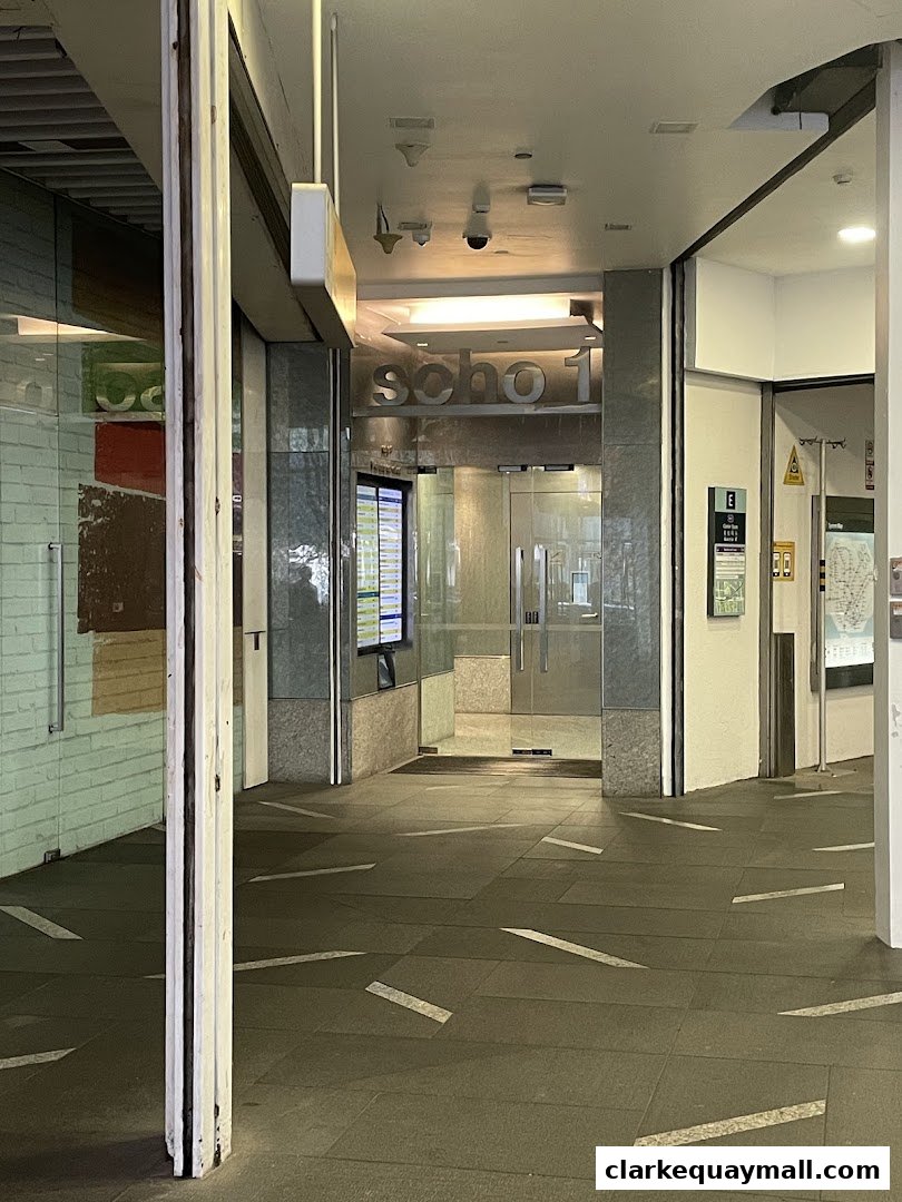 Entrance to a shop with glass doors and signage above.
