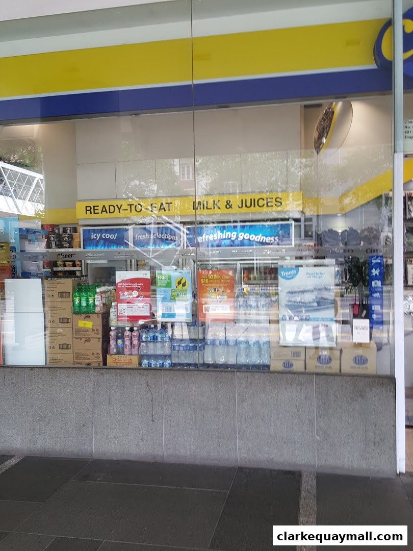 A shop window displaying a variety of drinks, snacks, and promotional posters.