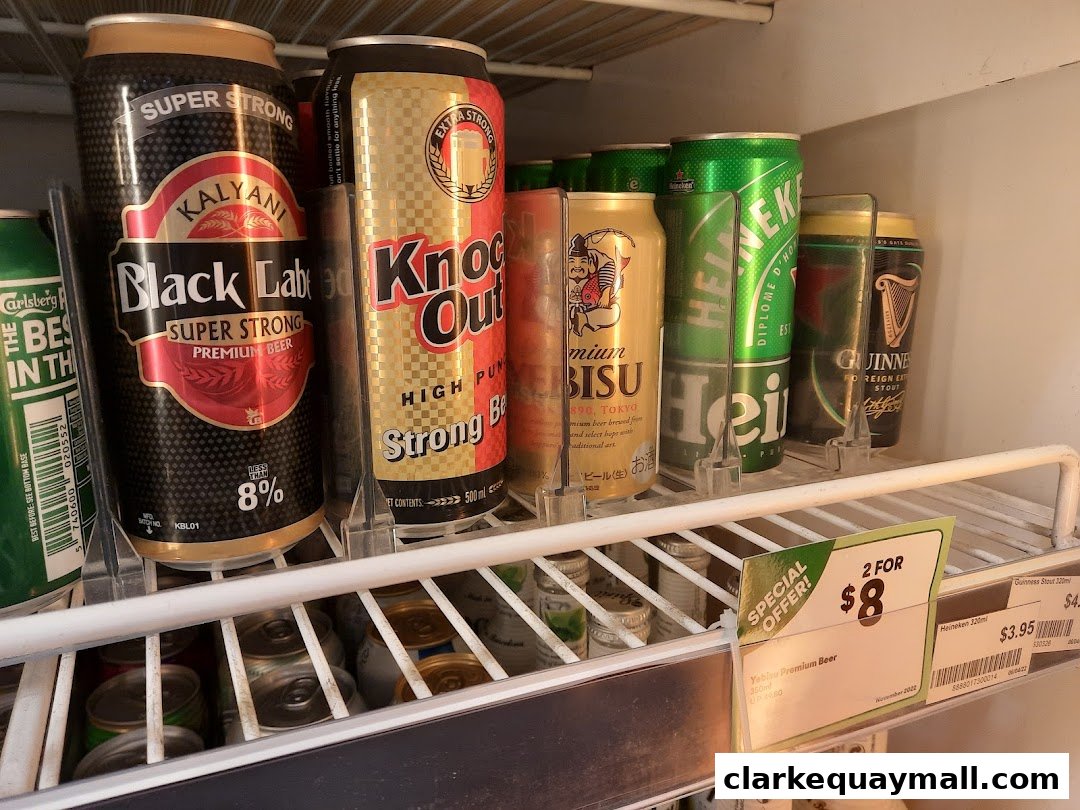 A refrigerator shelf stocked with various cans of beer, including Black Label, Knock Out, Yebisu, Heineken, and Guinness.