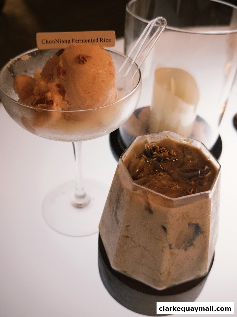 A close-up of a dessert and a drink, with a sign reading 'ChouNiang Fermented Rice'.