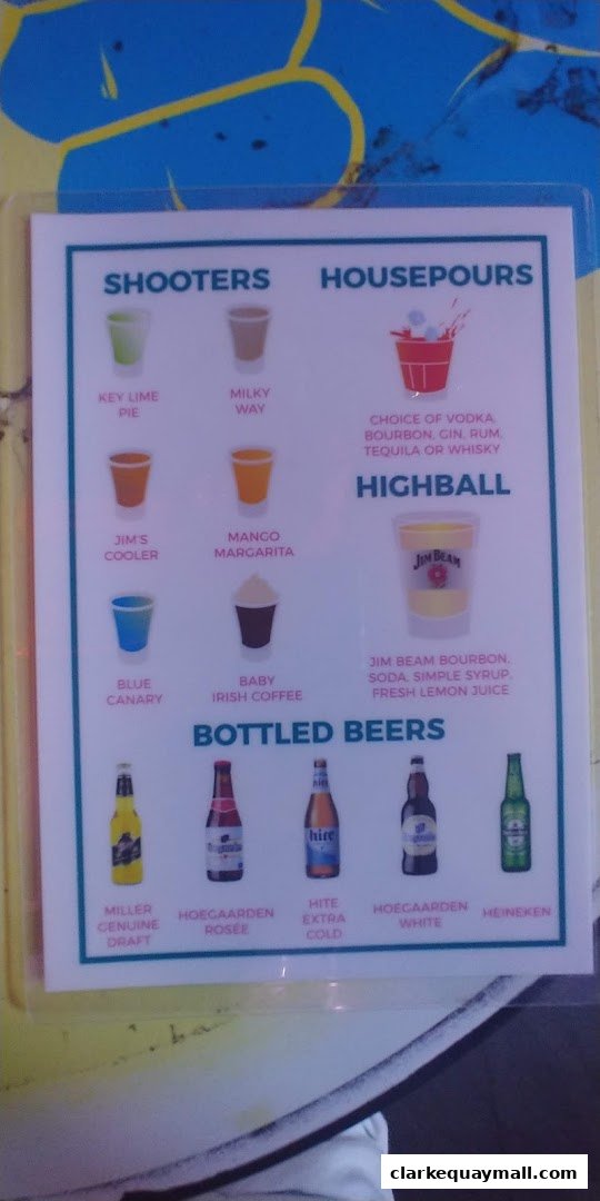 A menu displaying various shooters, house pours, and bottled beers with illustrations.