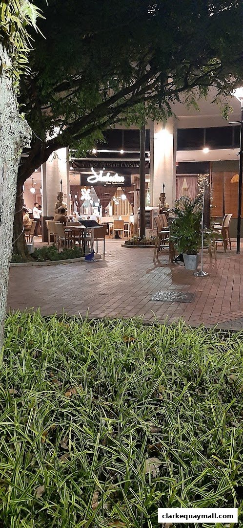 A restaurant called 'Shalimar' with Persian cuisine is visible at night.