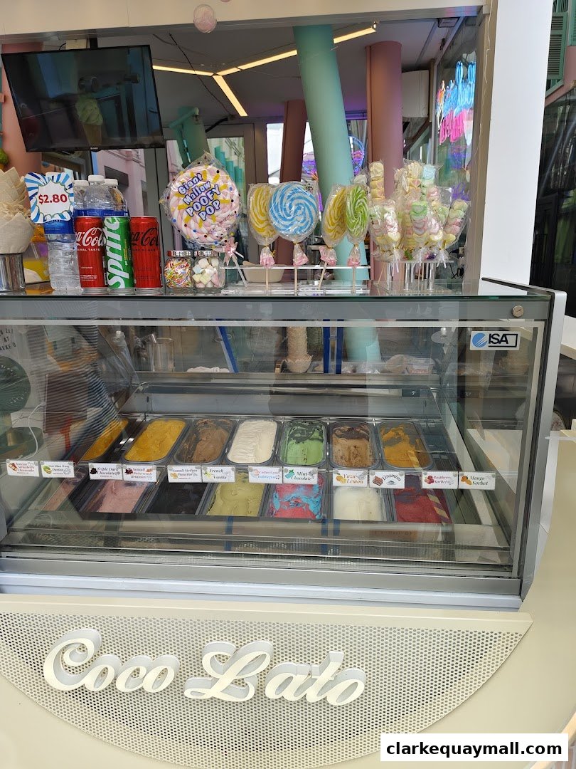 A display case filled with various flavors of gelato and a selection of colorful candies and lollipops.