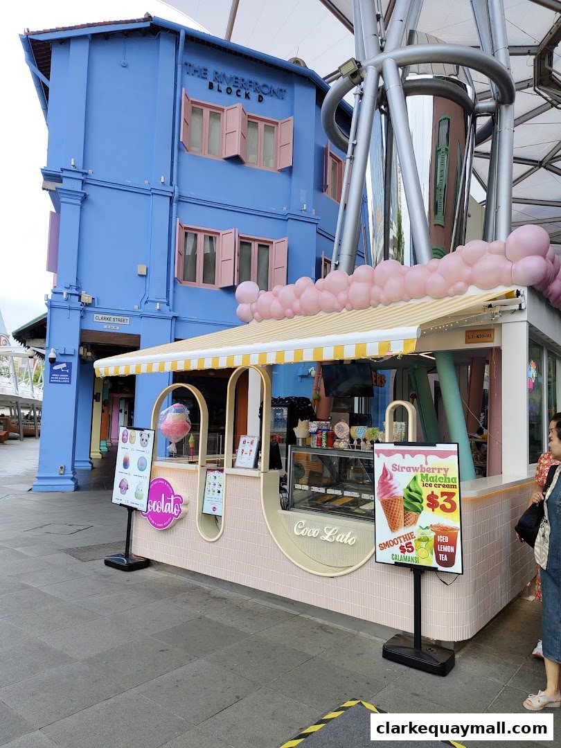 A colorful ice cream shop called Cocolato with a display of ice cream and drinks.