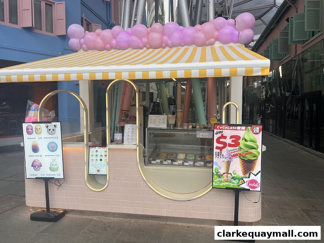 A Cocolato ice cream kiosk with colorful balloons and a promotional sign.