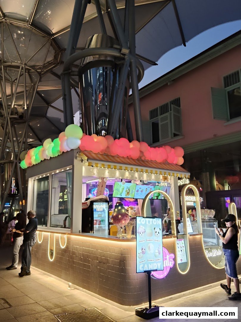 A brightly lit Cocolato shop with colorful balloons and a menu board.