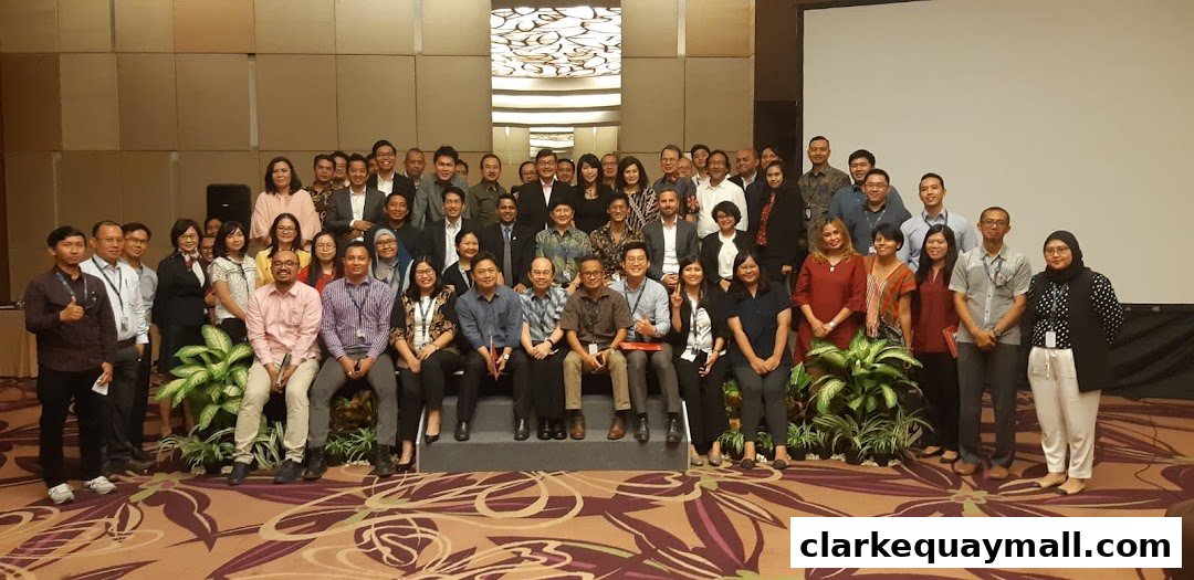 A large group of people posing for a photo in a conference or event setting.