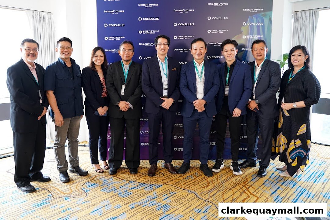 A group of ten professionals posing for a photo in front of a backdrop with the Consulus logo.