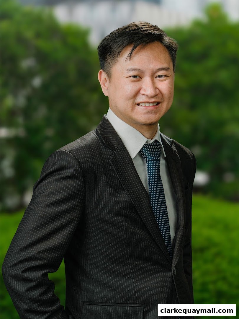 A professional portrait of a man in a pinstripe suit and tie.