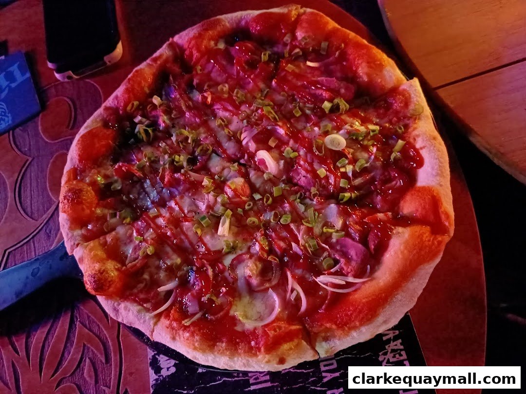 A delicious pizza with toppings and a drizzle of sauce, served on a wooden board.