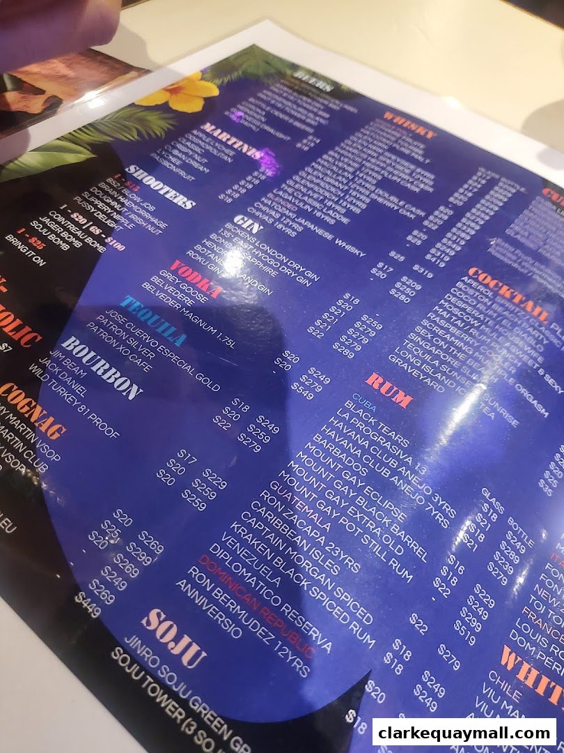 A close-up view of a colorful drink menu with various categories and prices.