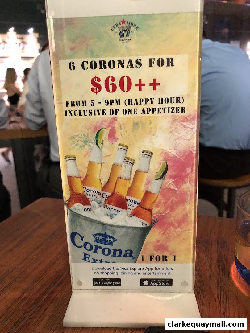A promotional sign for Cuba Libre Cafe Bar offering 6 Coronas for $60++ during happy hour.