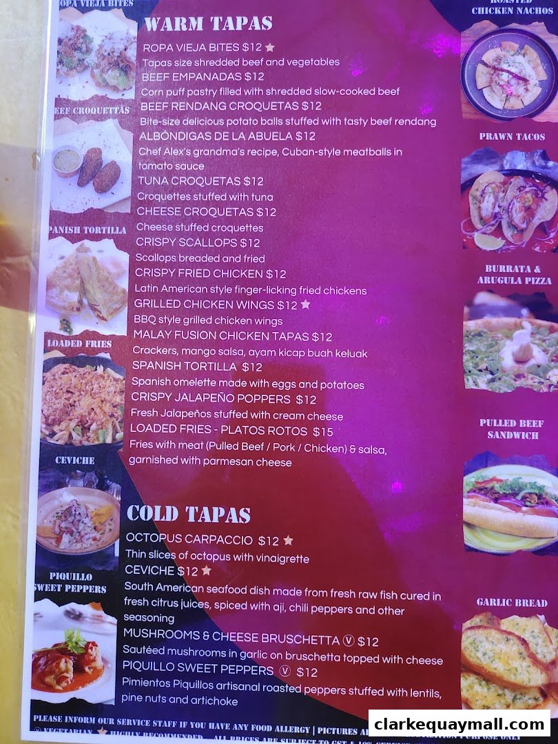 A vibrant menu from Cuba Libre Cafe Bar, showcasing a variety of tapas and dishes with enticing descriptions.