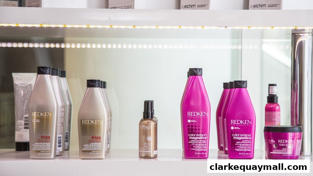 A shelf displaying various Redken hair care products, including shampoos and conditioners.