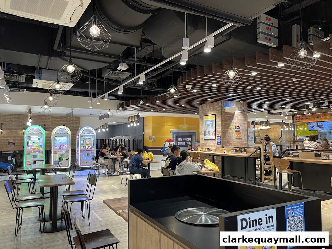 Interior view of DON DON DONKI with seating, claw machines, and customers dining.