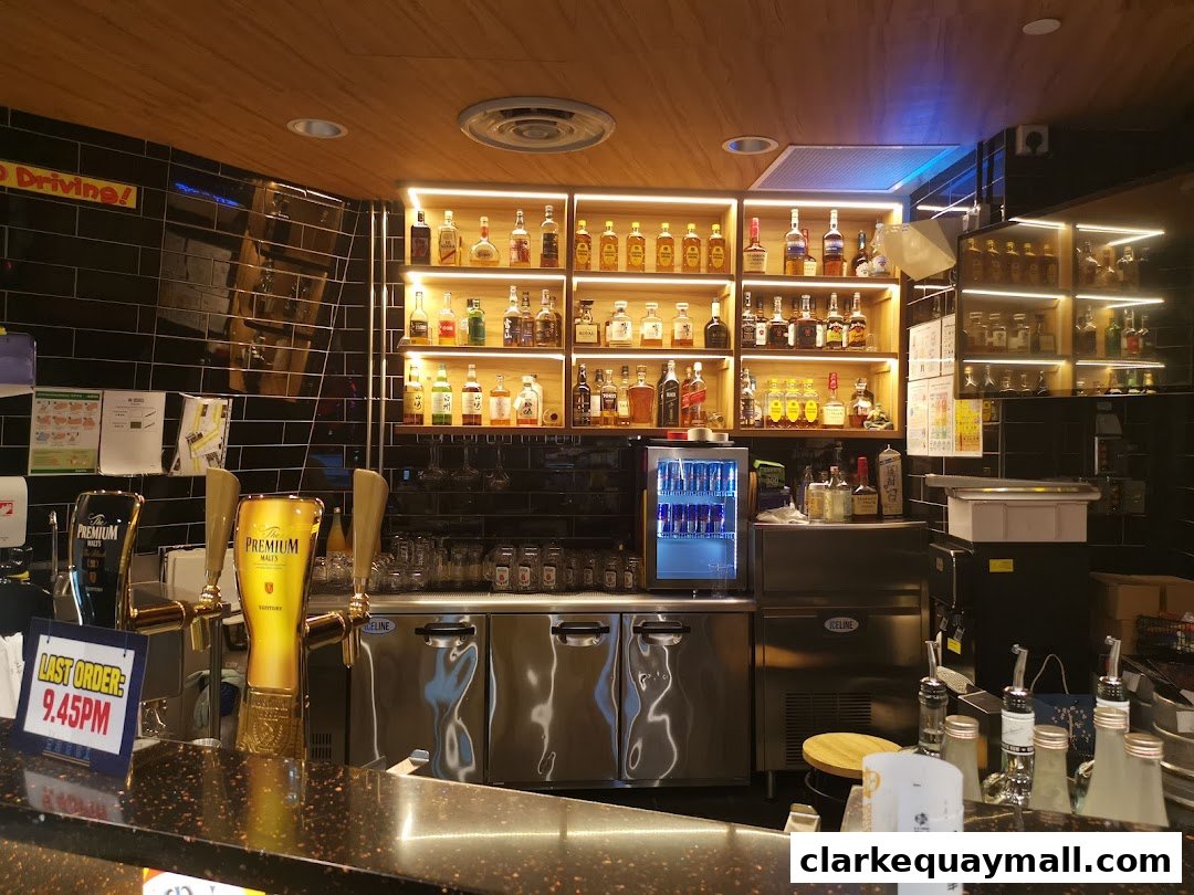 A well-stocked bar with shelves of liquor bottles, beer taps, and a mini-fridge.