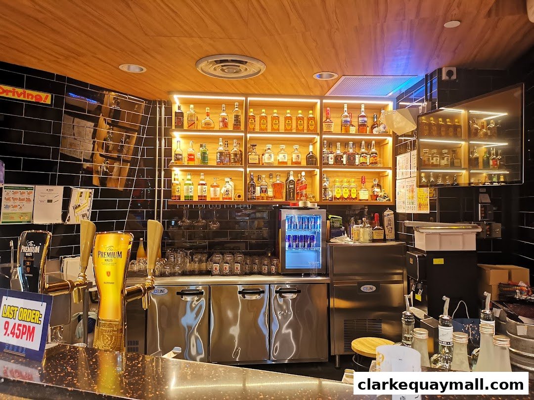 A well-stocked bar with shelves of liquor bottles, beer taps, and a mini-fridge.