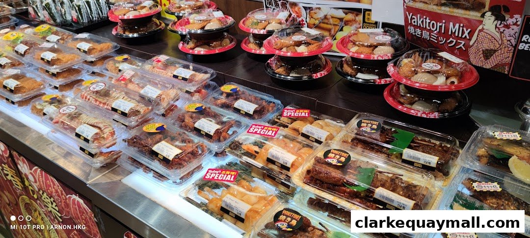 A display of various pre-packaged Japanese foods, including yakitori and other snacks.