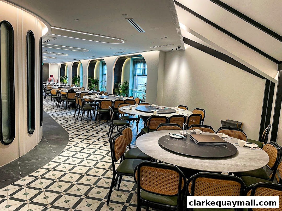 Interior view of a spacious Chinese restaurant with multiple round tables and chairs.