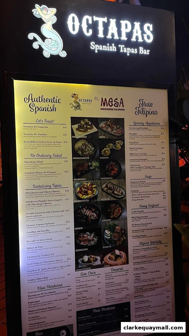 A menu board displaying Spanish and Filipino dishes with prices and images.
