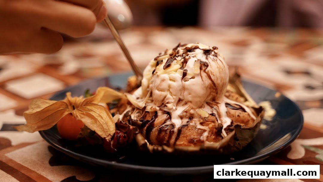 A close-up of a dessert with ice cream, chocolate sauce, and fruit on a plate.