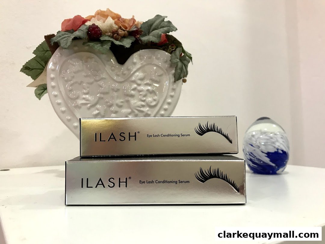 Two boxes of ILASH Eye Lash Conditioning Serum are displayed with decorative items.