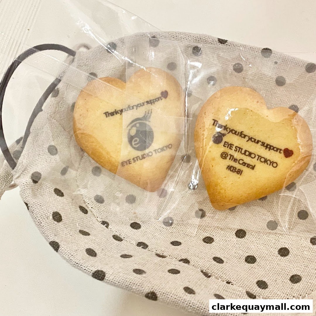 Heart-shaped cookies with 'Eye Studio Tokyo' branding in a polka dot fabric basket.