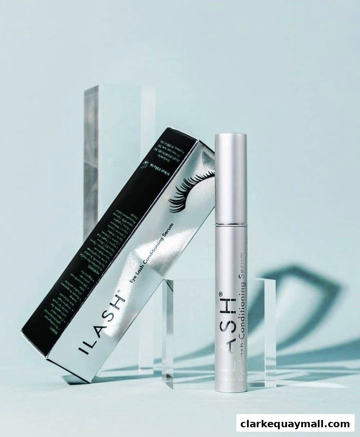 A bottle and box of ILASH Eye Lash Conditioning Serum are displayed against a light blue background.