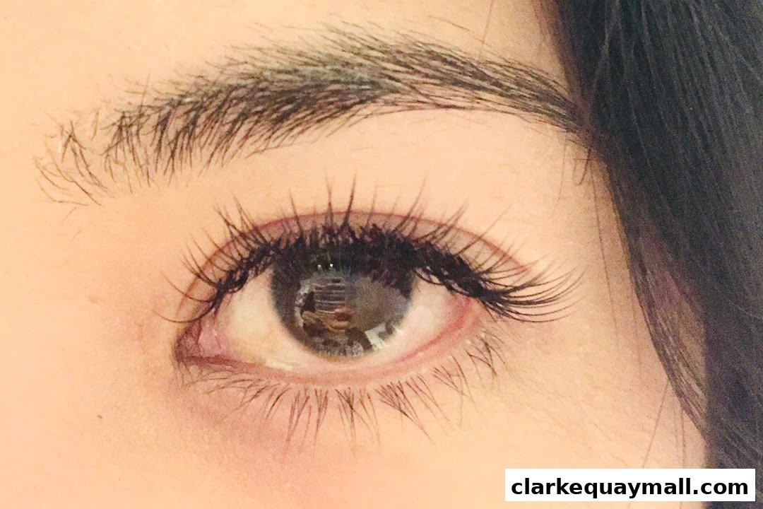 A close-up shot of a woman's eye with beautifully applied false eyelashes.