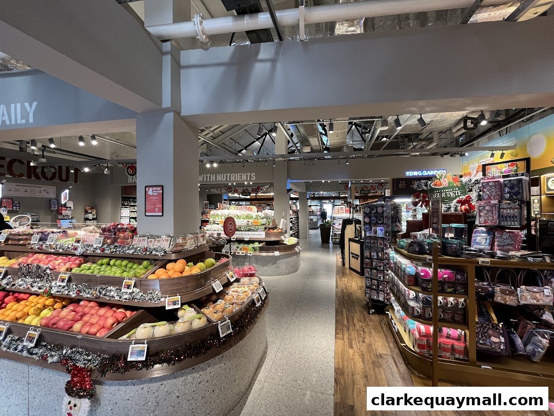 Interior view of a well-stocked grocery store with fresh produce and gift items.