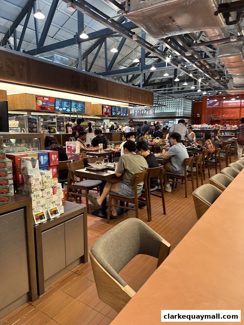 Interior view of a busy FairPrice Finest supermarket with customers dining and shopping.