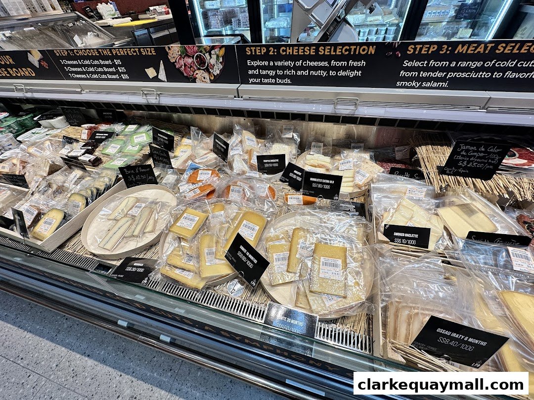 A display of various cheeses and cold cuts available for purchase at FairPrice Finest.