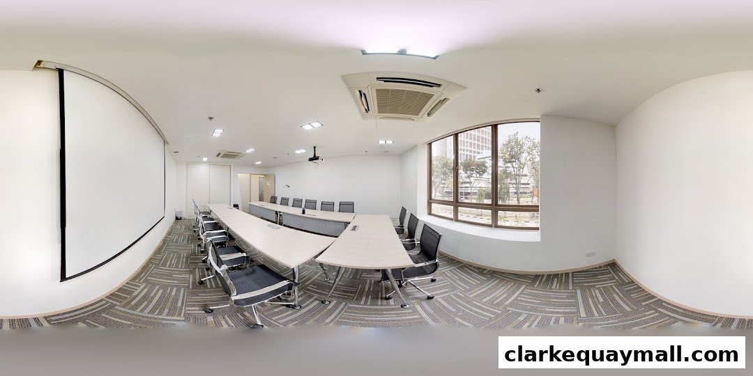A modern conference room with a long table, chairs, projector, and large windows.