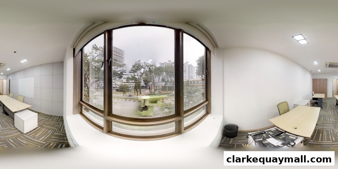 Interior view of a modern office space with desks, chairs, and large windows overlooking a city.
