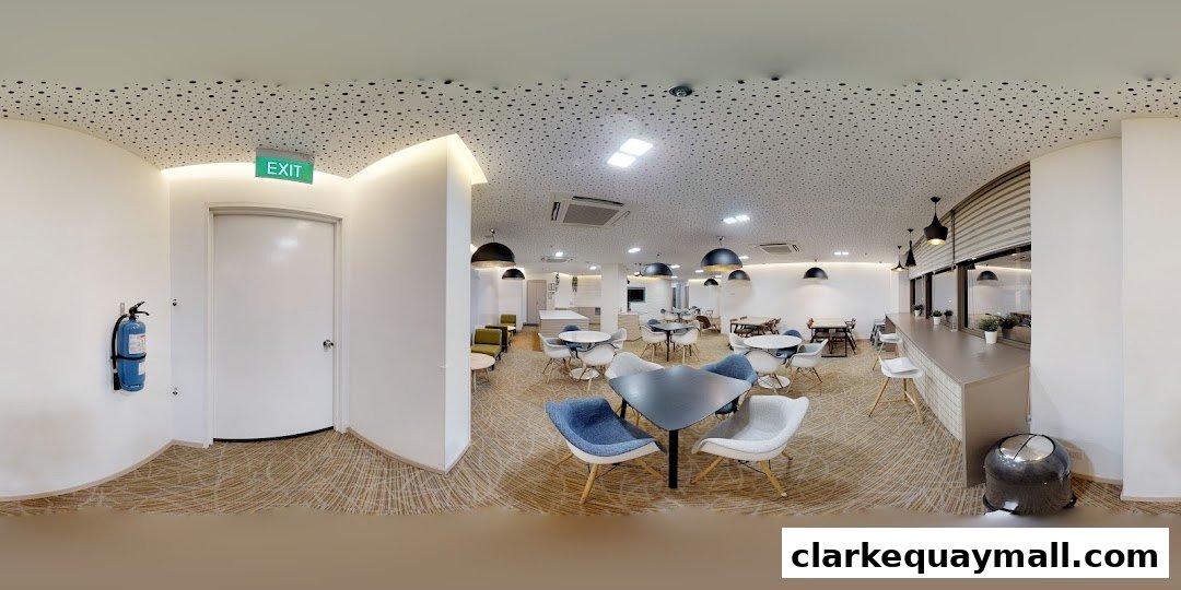 A modern lounge area with contemporary furniture, tables, and chairs, featuring an exit sign.