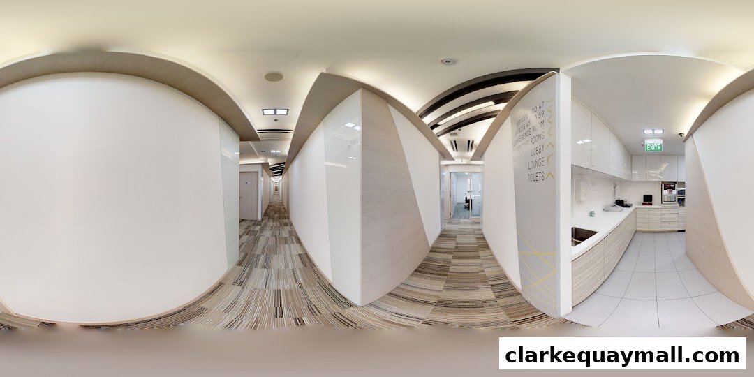 A modern office hallway with directional signage and a pantry area.