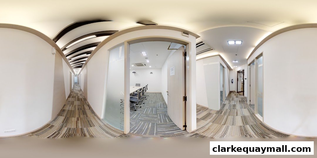 A modern office hallway with meeting rooms and a patterned carpet.