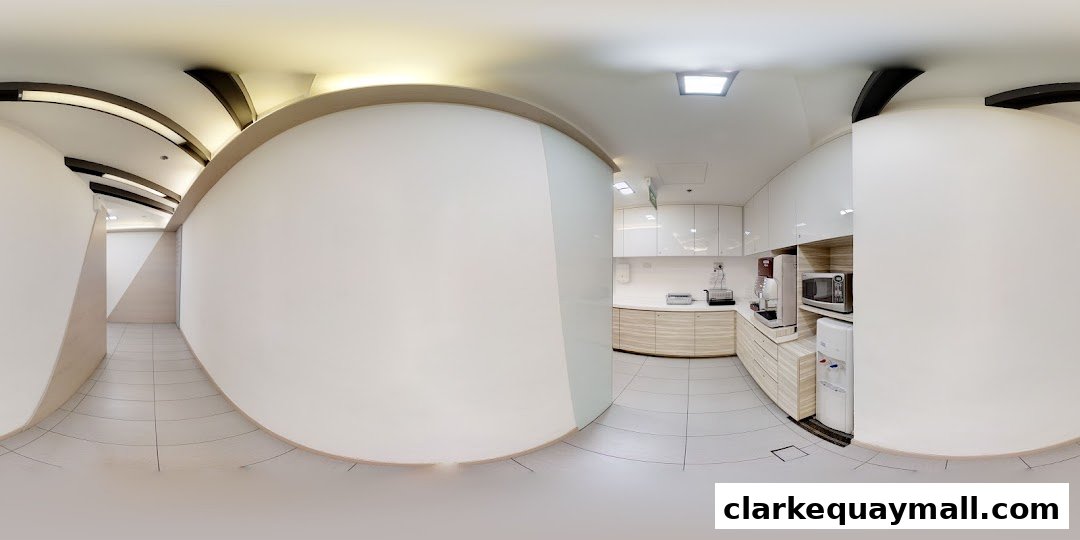 Interior view of a modern office pantry area with white cabinets, appliances, and a water dispenser.
