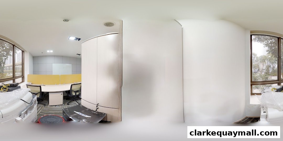 Modern office space with cubicles, desks, chairs, and large windows.