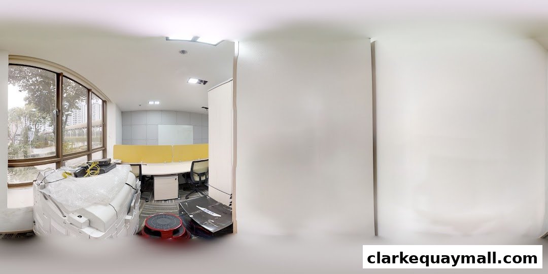 An office space with desks, chairs, and a large window overlooking a city.