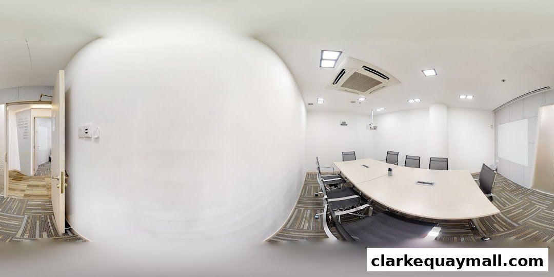 A modern conference room with a large table, chairs, and a whiteboard.